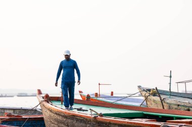 Varanasi, Uttar Pradesh, India - November 2022: Tourists enjoying boat side in the river ganges along with the herd of sea gulls at varanasi.