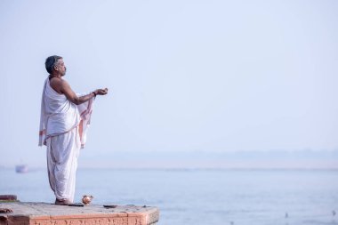 Varanasi, Uttar Pradesh, India - November 2022: Portrait of Unidentified Indian brahmin priest on ghat near river ganges in varanasi city.