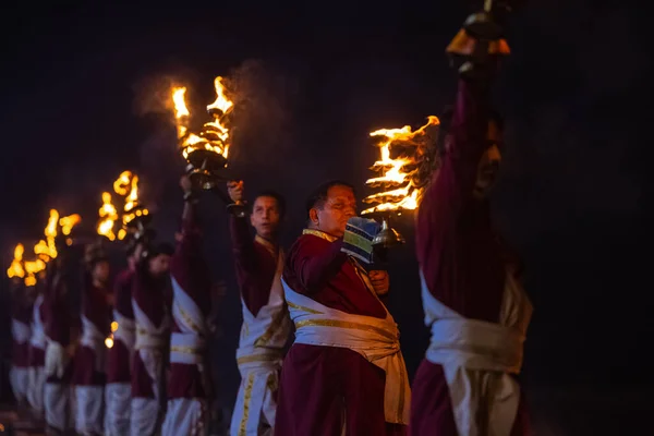 stock image Rishikesh, Uttarakhand, India - October 2022: Portrait of hindu male priests performing river Gange aarti with fire flame in hands at triveni ghat to worship river ganges. Ganga aarti performed in night.