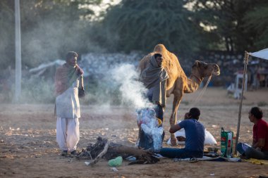 Pushkar, Rajasthan, India - November 2022: Pushkar Fair, camel trader in ethnic dress at fair ground during pushkar fair.