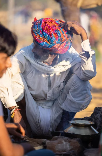 Pushkar, Rajasthan, India - November 2022: Pushkar Fair, Portrait of an camel trader in ethnic dress and rajasthani turban on fair ground during pushkar fair.