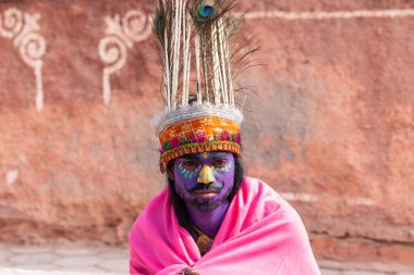 Bikaner, Rajasthan, India - January 2023: Camel festival, Portrait of young artist with painted face of animal while participating in the parade of annual camel festival in Bikaner. Selective focus.