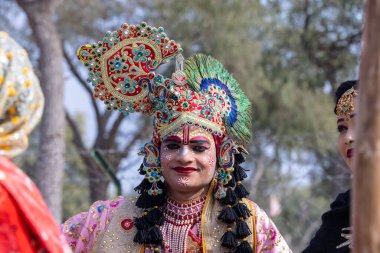 Bikaner, Rajasthan, India - January 2023: Portrait of an young beautiful woman from kashmir in traditional dress smiling while participating in bikaner camel festival parade.