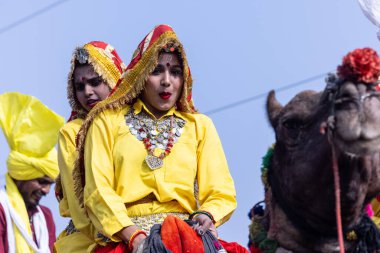 Bikaner, Rajasthan, India - January 2023: Camel Festival Bikaner, Group of young beautiful women in traditional dress and jewellery of rajasthan while participating in the parade. Selective focus.