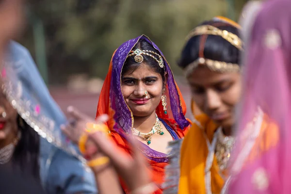 stock image Bikaner, Rajasthan, India - January 2023: Camel Festival Bikaner, Group of young beautiful girls in traditional dress and jewellery of rajasthan while participating in the parade. Selective focus.