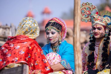 Bikaner, Rajasthan, India - January 2023: Portrait of an young beautiful girl from kashmir in traditional dress and veil on face participating in bikaner camel festival parade. Selective focus.