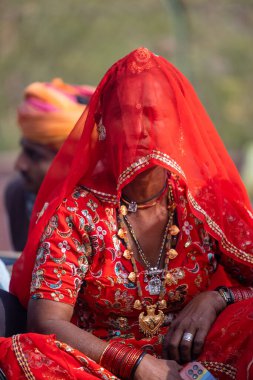Bikaner, Rajasthan, India - January 2023: Camel festival, Portrait of an young and beautiful female in traditional rajasthani lehanga and traditional jewelery during the festival at bikaner