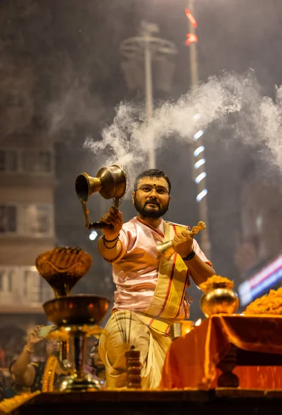 stock image Varanasi, Uttar Pradesh, India - November 2022: Ganga aarti, Portrait of an young priest performing river ganges evening aarti at dasaswamedh ghat in traditional dress with sanatan hindu rituals.