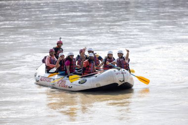 Rishikesh, Uttarakhand, India - October 2022: River rafting, Group of unidentified people enjoyinh river rafting in river ganges at rishikesh in boat. Rishikesh is famous for rafting along with yoga. clipart