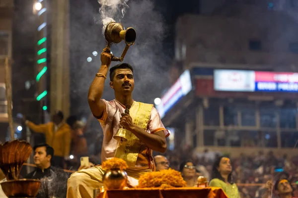 stock image Varanasi, Uttar Pradesh, India - November 2022: Ganga aarti, Portrait of an young priest performing river ganges evening aarti at Dashashwamedh Ghat in traditional dress with sanatan hindu rituals.