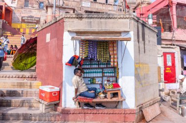 Varanasi, Uttar Pradesh, Hindistan - Kasım 2022: Banarsi paan nehir dükkanında müşteri bekleyen bir erkeğin portresi. Banarsi tavası dünya çapında ünlüdür. Organik ve sağlıklı..
