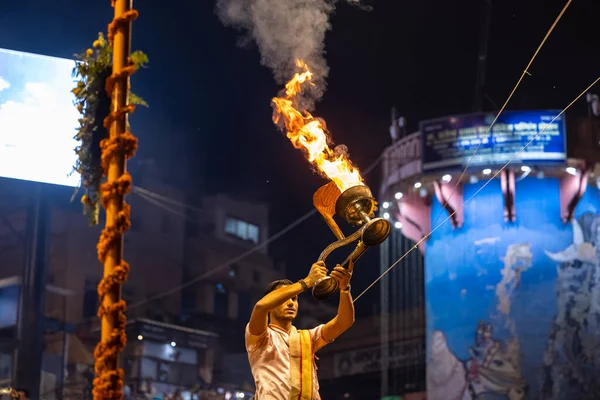 Stock image Varanasi, Uttar Pradesh, India - November 2022: Ganga aarti, Portrait of an young priest performing river ganges evening aarti at Dashashwamedh Ghat in traditional dress with sanatan hindu rituals.