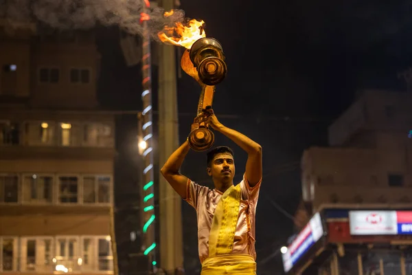 stock image Varanasi, Uttar Pradesh, India - November 2022: Ganga aarti, Portrait of an young priest performing river ganges evening aarti at Dashashwamedh Ghat in traditional dress with sanatan hindu rituals.