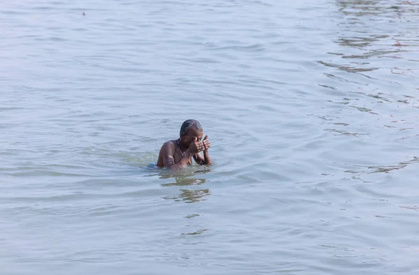 stock image Varanasi, Uttar Pradesh, India - November 2022: Portrait of unidentified male taking the holy dip in river ganges during sunrise to perform hindu rituals.