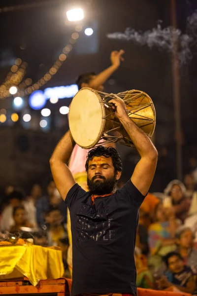 stock image Varanasi, Uttar Pradesh, India - November 2022: Ganga aarti, Portrait of an young priest performing river ganges evening aarti at assi Ghat in traditional dress with fire flame and rituals.