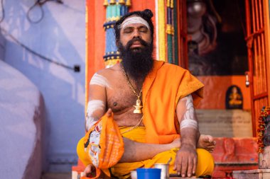 Varanasi, Uttar Pradesh, Hindistan - 20 Kasım 2022: Varanasi şehrinde geleneksel elbise içinde nehir çeteleri yakınlarındaki ghatlarda tanımlanamayan Hint kutsal sadhu erkek resimleri.