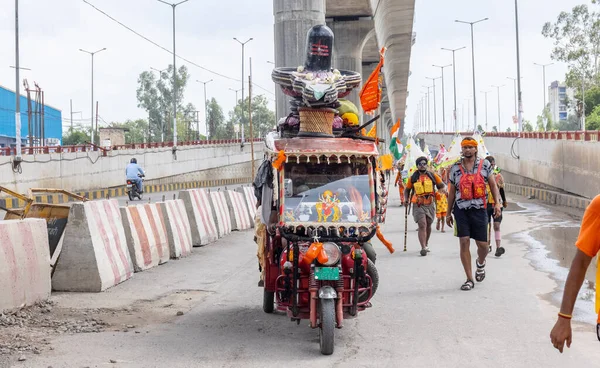 stock image Ghaziabad, Uttar Pradesh, India - July 24 2022: Portrait of hindu pilgrim performing kanwar yatra barefoot to worship lord shiv during monsoon time and carrying holy water of river ganges.