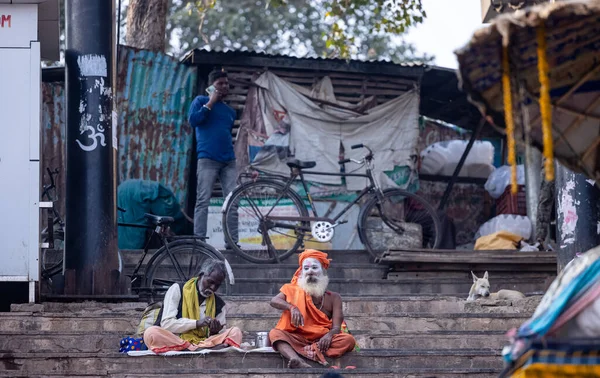 stock image Varanasi, Uttar Pradesh, India - November 20 2022: Portrait of Unidentified Indian holy sadhu male with painted face of ash sittings at dashashwamedh ghat near river ganges 