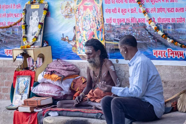 stock image Varanasi, Uttar Pradesh, India - November 20 2022: Portrait of Unidentified Indian holy sadhu male sittings at dashashwamedh ghat near river ganges in varanasi city in traditional dress.