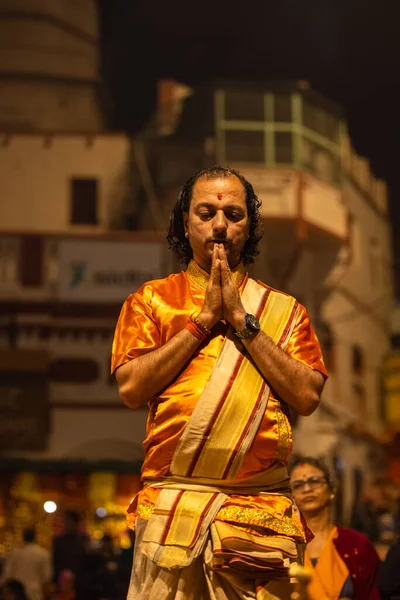 stock image Varanasi, Uttar Pradesh, India - November 20 2022: Ganga aarti, Portrait of young priest performing holy river ganges evening aarti at dashashwamedh ghat in traditional dress with hindu rituals.