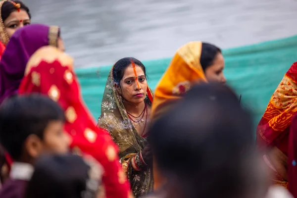 stock image Ghaziabad, Uttar Pradesh, India - October 30 2022: Chhath Puja, Indian hindu female devotee performing rituals of chhath puja while standing in river to worship lord sun during sunset.