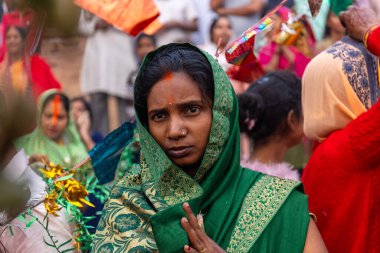 Ghaziabad, Uttar Pradesh, India - October 30 2022: Chhath Puja, Indian hindu female devotee performing rituals of chhath puja while standing in river to worship lord sun during sunset. clipart