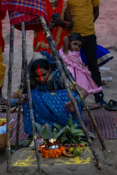 stock image Ghaziabad, Uttar Pradesh, India - October 30 2022: Chhath Puja, Indian hindu female devotee performing rituals of chhath puja while standing in river to worship lord sun during sunset.