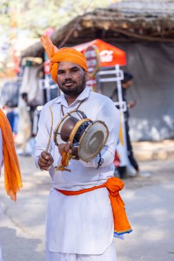 Faridabad, Haryana, Hindistan - 4 Şubat 2023: Turistleri eğlendirmek için surajkund el sanatları fuarı sırasında Haryana 'nın erkek sanatçısı portresi.