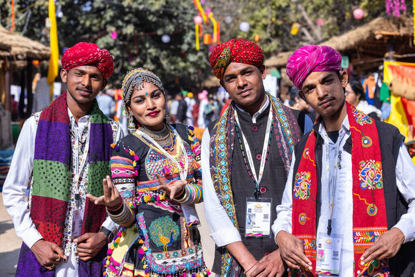 Faridabad, Haryana, India - February 04 2023: Portrait of an female and male artists in traditional clothes at surajkund craft fair