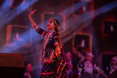 Puşkar, Rajasthan, Hindistan - Kasım 05 2022: Rajasthani halk dansları yapan kadın ressamın portresi geleneksel elbisesiyle pulkar fuarında gülümseyerek 