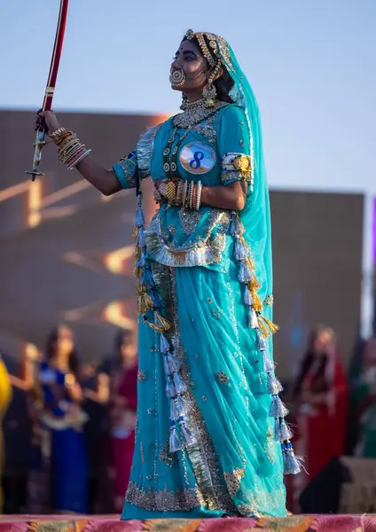 stock image Bikaner, Rajasthan, India - January 14 2023: Portrait of young beautiful indian woman in ethnic rajasthani lehenga choli dress participating in miss marwar fashion show during bikaner camel festival