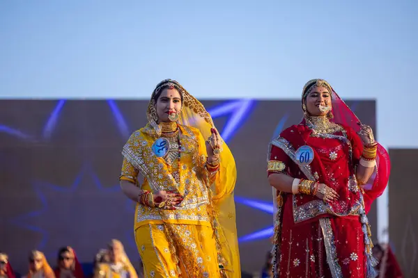 Stock image Bikaner, Rajasthan, India - January 14, 2023: Portrait of young beautiful indian women in ethnic rajasthani lehenga choli dresses participating in miss marwar fashion show during bikaner camel festival