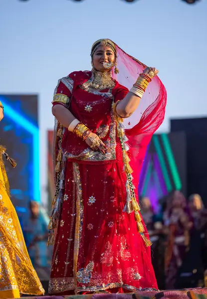 stock image Bikaner, Rajasthan, India - January 14 2023: Portrait of young beautiful indian woman in ethnic rajasthani lehenga choli dress participating in miss marwar fashion show during bikaner camel festival