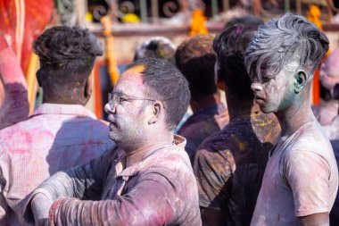 Varanasi, Uttar Pradesh, Hindistan - 04 Mart 2023: Masan Holi, Mankarnika ghat 'ındaki bayram bayramını renklerle ve eğlenceyle kutlayan kimliği belirsiz bir grup insan. Holi festivalinde mutlu yüzler