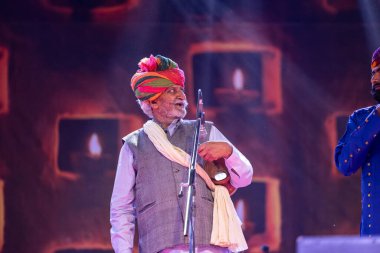 Pushkar, Rajasthan, India - November 06 2022: Portrait of male folk artists from rajasthan performing in stage during pushkar camel fair in traditional dress and colourful turban clipart