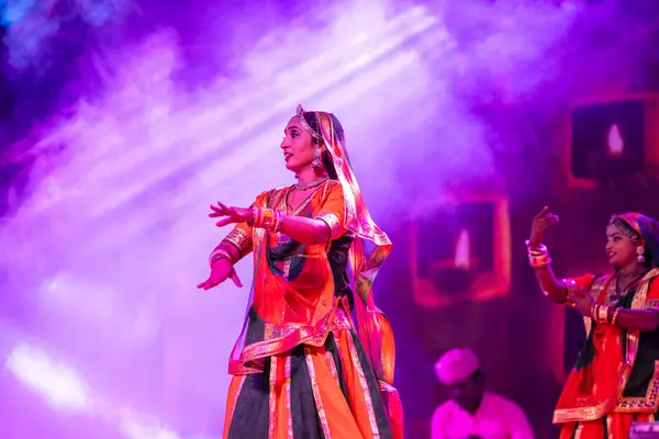 stock image Pushkar, Rajasthan, India - November 05 2022: Portrait of young beautiful female artist performing folk dance with veil on head during pushkar fair in colorful ethnic rajasthani dress.