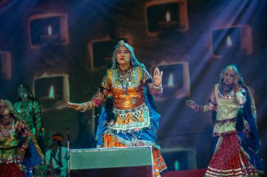 Puşkar, Rajasthan, Hindistan - Kasım 06 2022: Rajasthani halk dansını renkli etnik rajasthani elbise ve mücevherleriyle yapan kadın sanatçı.