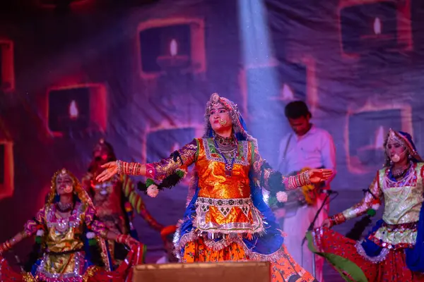 stock image Pushkar, Rajasthan, India - November 06 2022: Female artist performing rajasthani folk dance on stage at pushkar fair in colorful ethnic rajasthani dress and jewellery.