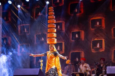 Pushkar, Rajasthan, India - November 06 2022: Artist performing rajasthani folk dance on stage at pushkar fair in colorful ethnic rajasthani dress and jewellery. clipart