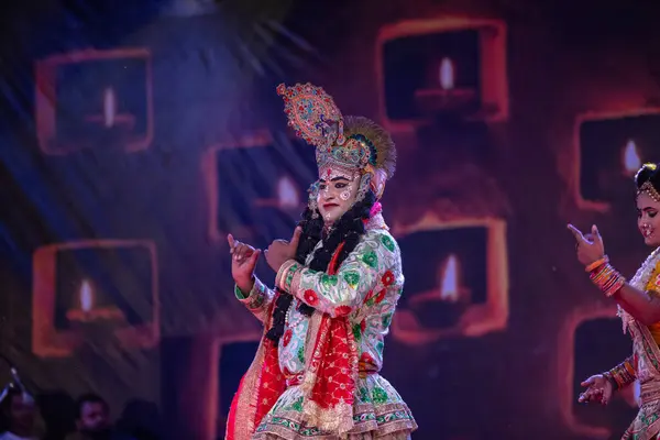 stock image Pushkar, Rajasthan, India - November 06 2022: Male artist performing flowers holi as lord krishna during pushkar fair in colourful ethnic clothes.