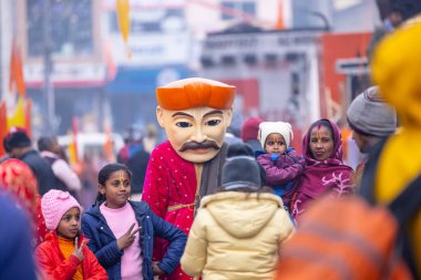 Ghaziabad, Uttar Pradesh, India - January 28 2024: Portrait of hindu devotees participating in rath yatra of lord jagannath and chanting krishna. clipart