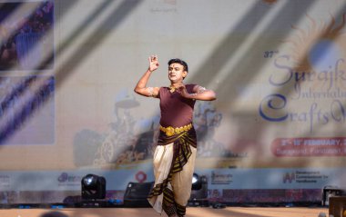 Faridabad, Haryana, Hindistan - 17 Şubat 2024: Güney Hintli erkek sanatçı surajkund sanatları fuarında klasik dans kuchipudi performansı sergiliyor.