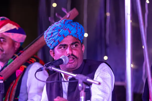 Stock image Bikaner, Rajasthan, India - January 13 2023: Camel Festival, Portrait of rajasthani male artist performing on stage during bikaner camel festival in traditional rajasthani dress and colourful turban.