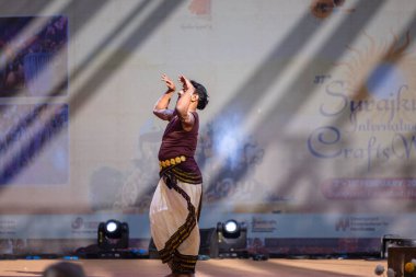 Faridabad, Haryana, Hindistan - 17 Şubat 2024: Güney Hintli erkek sanatçı surajkund sanatları fuarında klasik dans kuchipudi performansı sergiliyor.