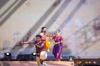 Faridabad, Haryana, Hindistan - 17 Şubat 2024: Güney Hintli erkek ve kadın sanatçı Surajkund sanatları fuarında klasik dans kuchipudi performansı sergiliyorlar.