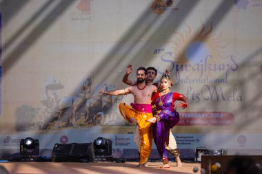 Faridabad, Haryana, India - February 17 2024: Portrait of male and female south indian artist performing classical dance kuchipudi on stage at surajkund craft fair. clipart