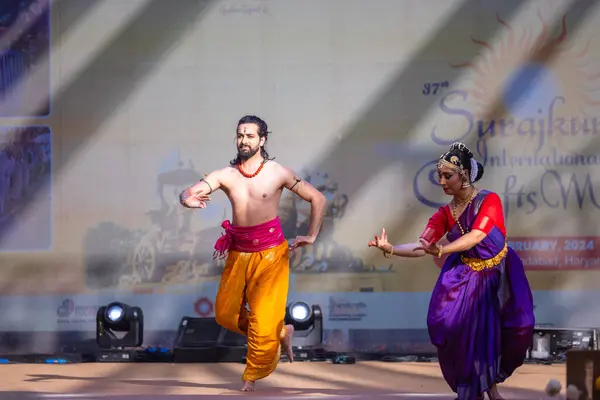 stock image Faridabad, Haryana, India - February 17 2024: Portrait of male and female south indian artist performing classical dance kuchipudi on stage at surajkund craft fair.