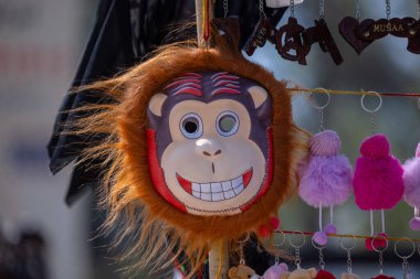 Handmade mask of monkey animal mask hanging at fair. Selective focus. clipart