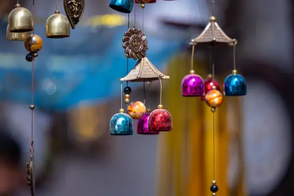 Stock image Hanging wind bells on shop with blur background at fair.