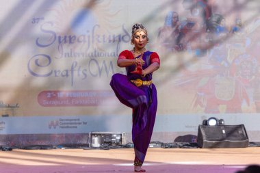 Faridabad, Haryana, India - February 17 2024: Portrait of a female south indian artist performing classical dance kuchipudi at surajkund craft fair in traditional saree and jewellery. clipart